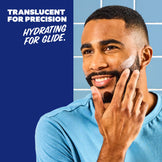 Man applying skincare product with text about product benefits on a blue background